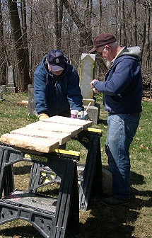 Garry Walls (left) and instructor PhilMcClure fit a broken stone together