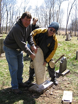Tim Beckman and Jerry Thompson dry fit a cleaned and repaired stone as Brother Roger Lester looks on
